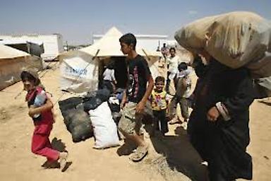 Refugiados sirios llegando al campamento Zaatari en Jordania