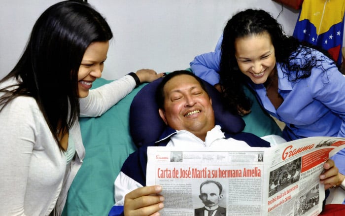 Presidente Chávez lee el Diario Granma junto a sus hijas