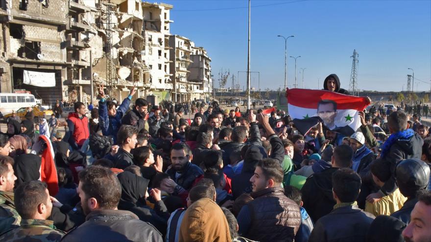 El pueblo sirio festejan en las calles de Alepo la evacuación de los grupos armados de la ciudad, 15 de diciembre de 2016.