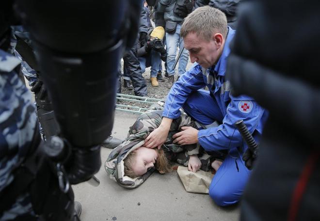 Un médico ruso atiende a una joven herida en la marcha por el Día de la Unidad del Pueblo, en Moscú