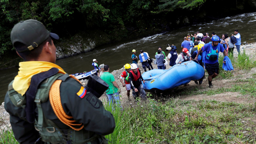 Ex miembros de las FARC y ahora instructores de rafting llevan una balsa inflable en Miravalle, Colombia, el 9 de noviembre de 2018.