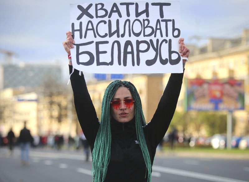 Manifestante muestra un cartel con la leyenda "Dejen de violar Bielorrusia", durante una marcha contra Lukashenko, en Minsk, Bielorrusia