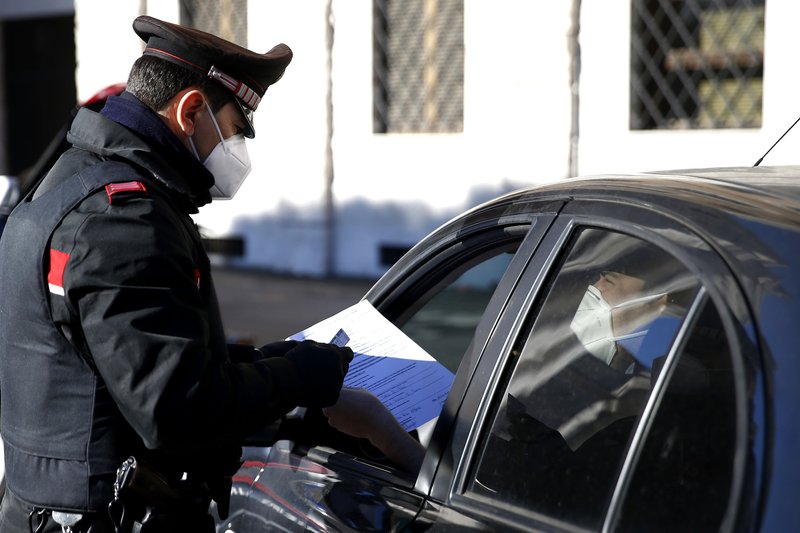 Agente de los carabinieri, chequea documentos en un control de acceso en Roma EL 15/3/2021