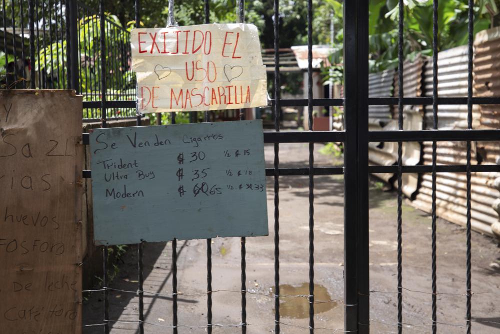 Letrero en el que se exige el uso de mascarilla durante la pandemia de COVID-19 cuelga en un portón a la entrada de una zona habitacional en Managua, Nicaragua