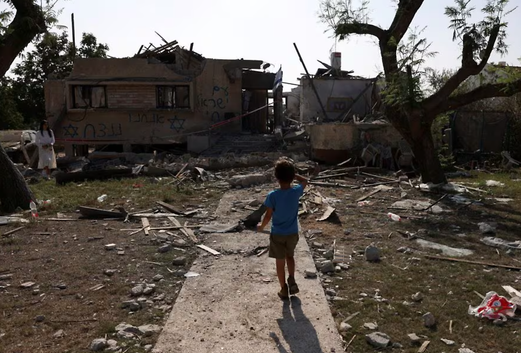 Un Niño mira una casa alcanzada por un cohete disparado desde la Franja de Gaza, en el centro de Israel, en medio del conflicto en curso entre Israel y el grupo islamista palestino Hamas