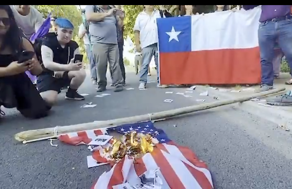 Queman bandera de EEUU frente a su embajada en Chile por agresión armada  contra Venezuela
